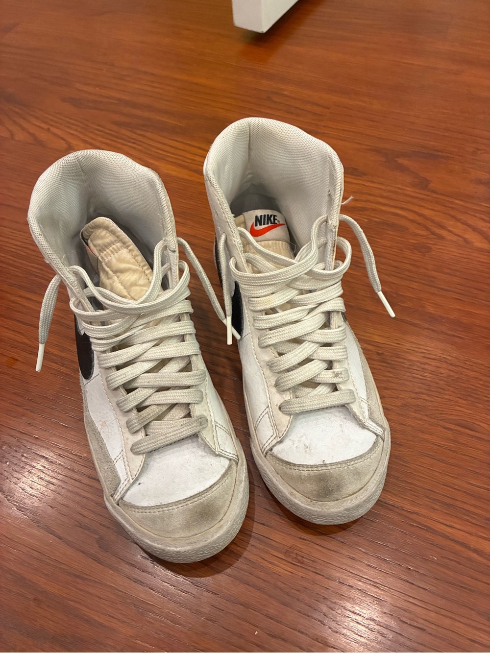 Nike White High-Top Sneakers with Black Swoosh